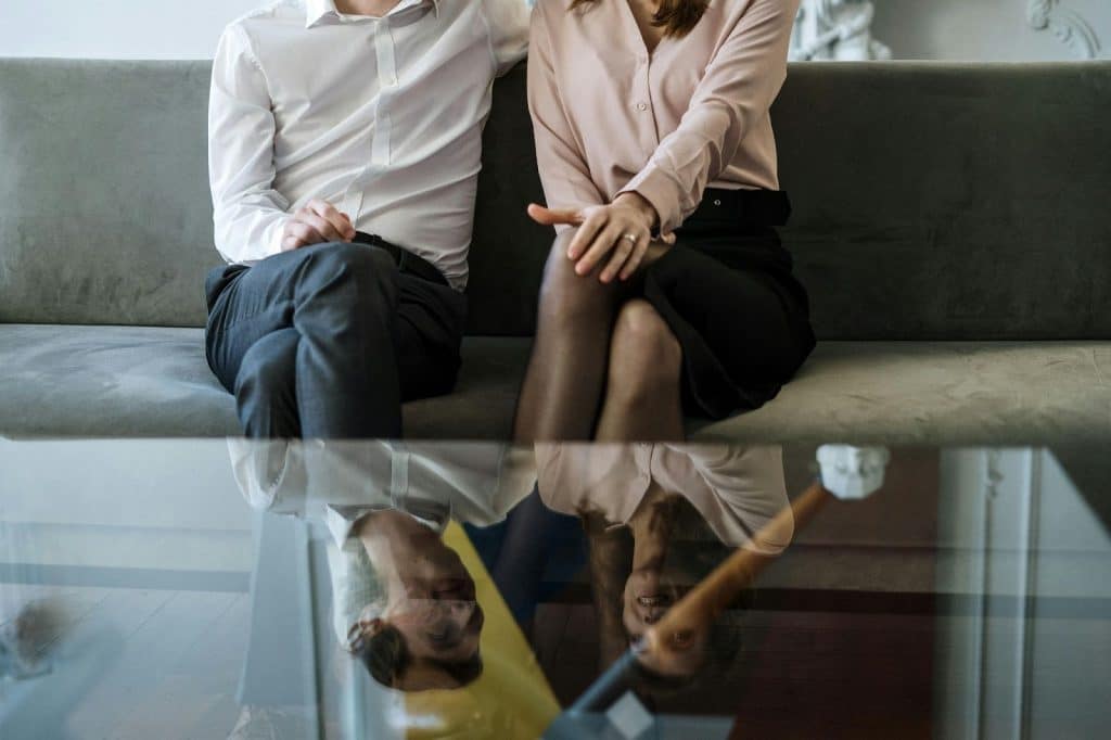 A man and woman sitting and close to each other