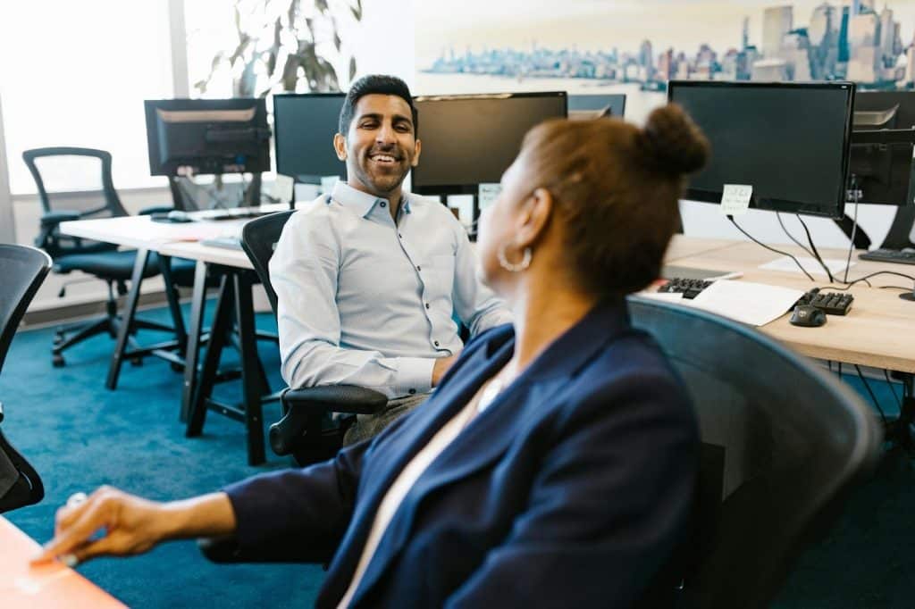 A man smiling to woman