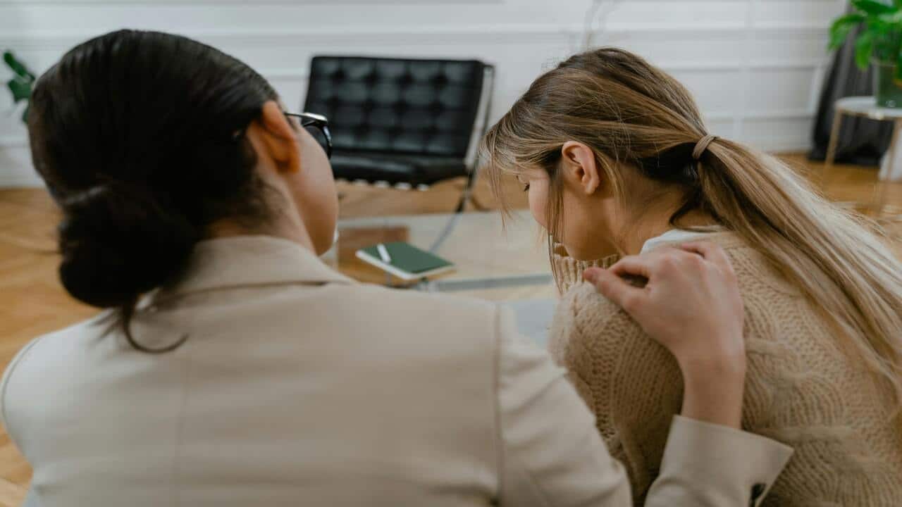 A woman comforting a crying friend
