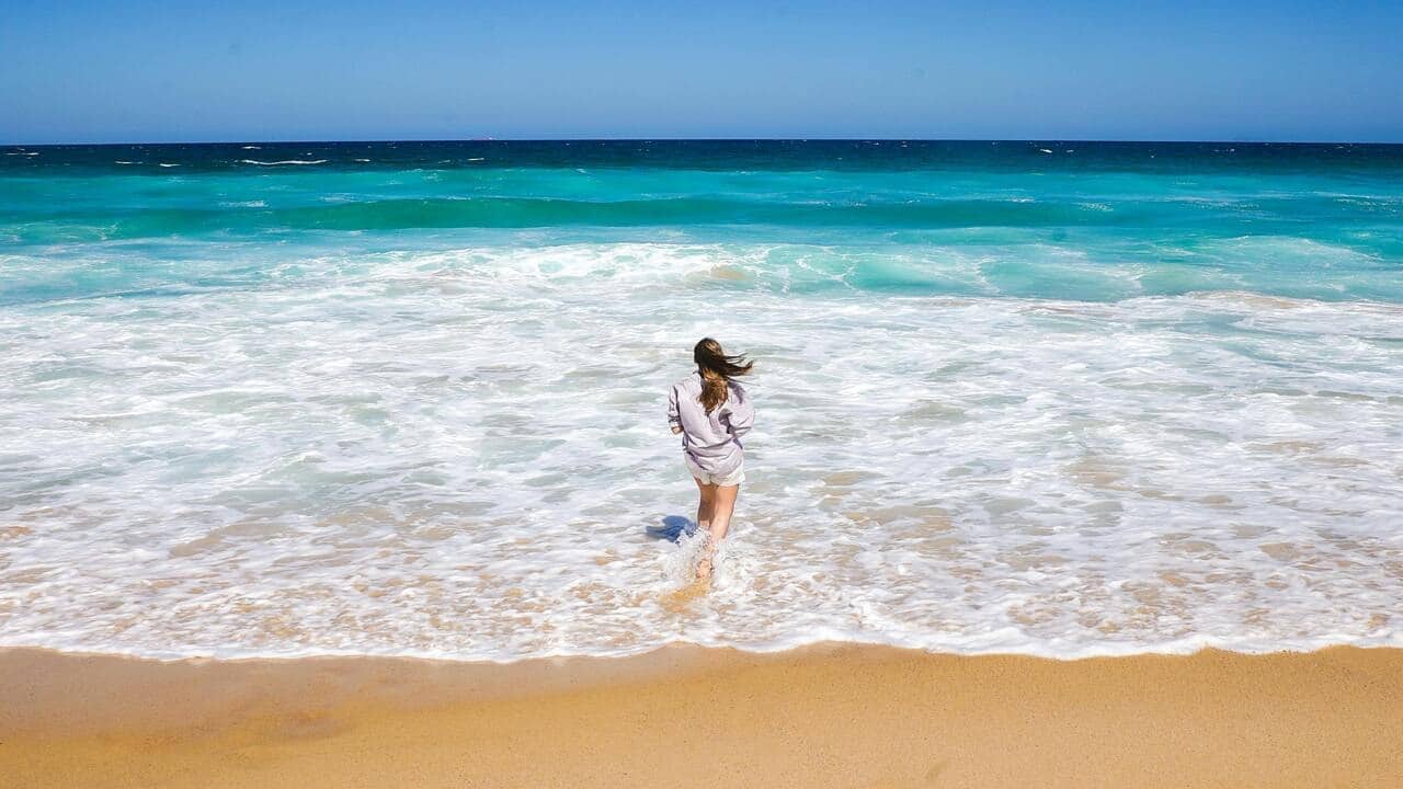 A woman standing on the shore