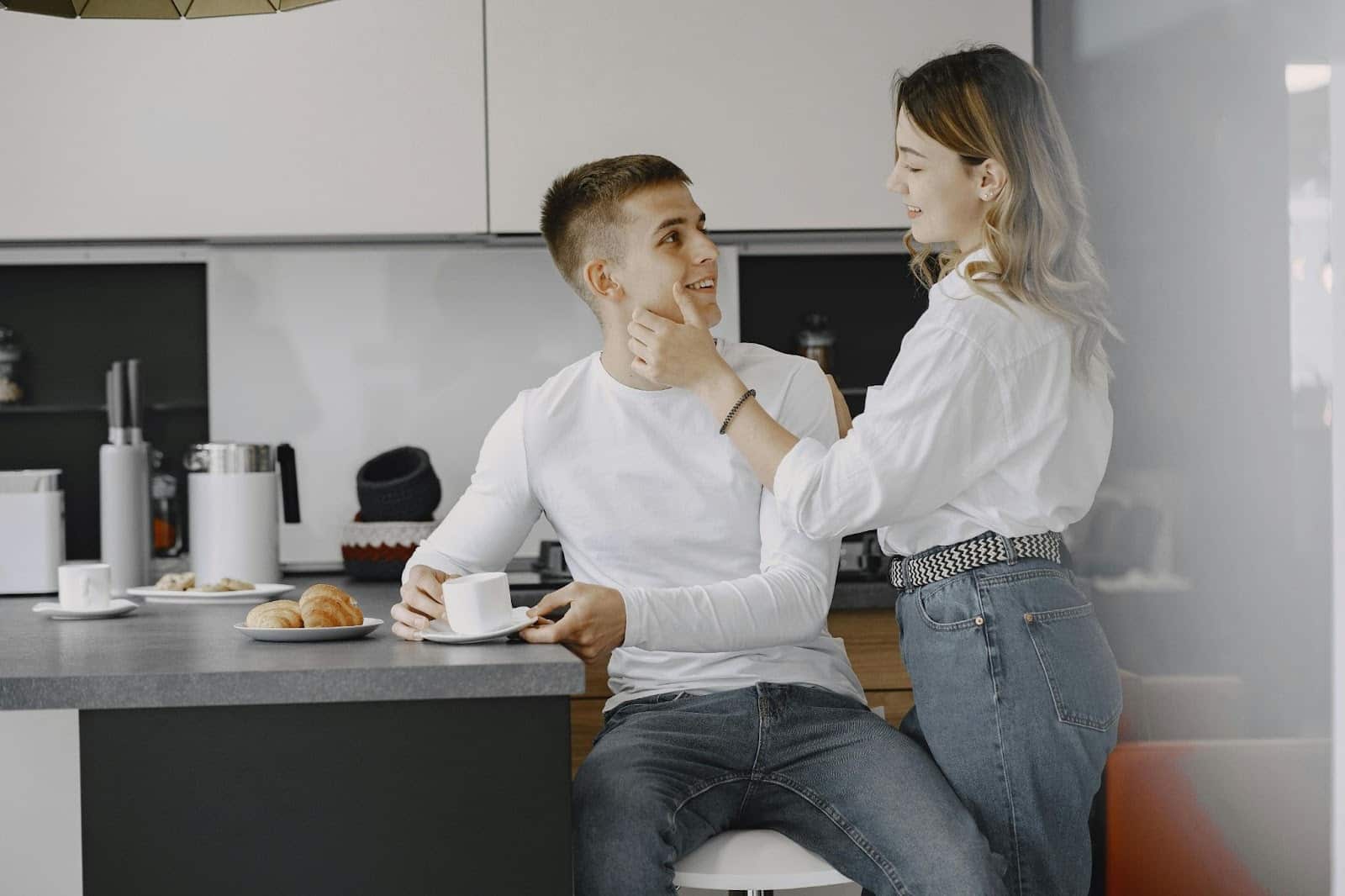 A woman holding a man’s face