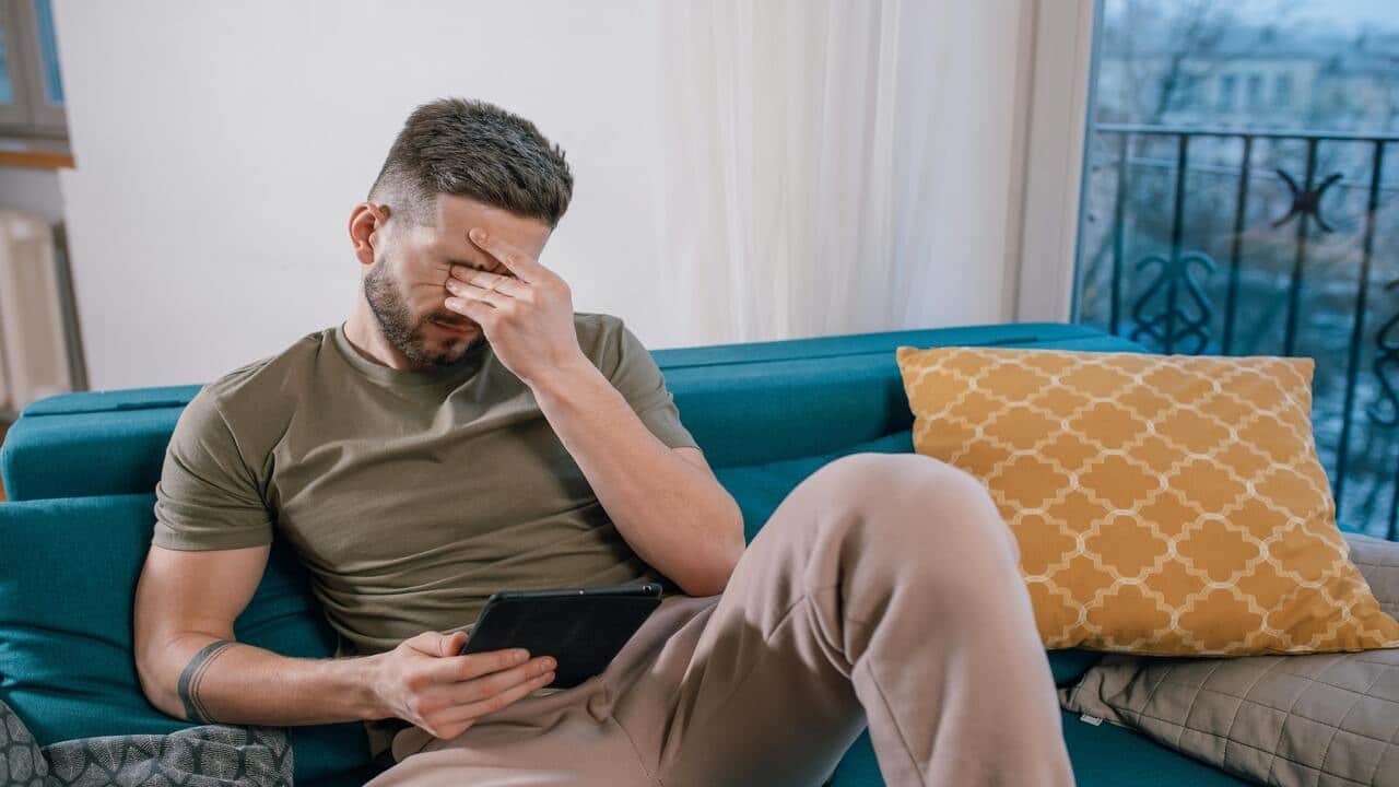 A man crying at home