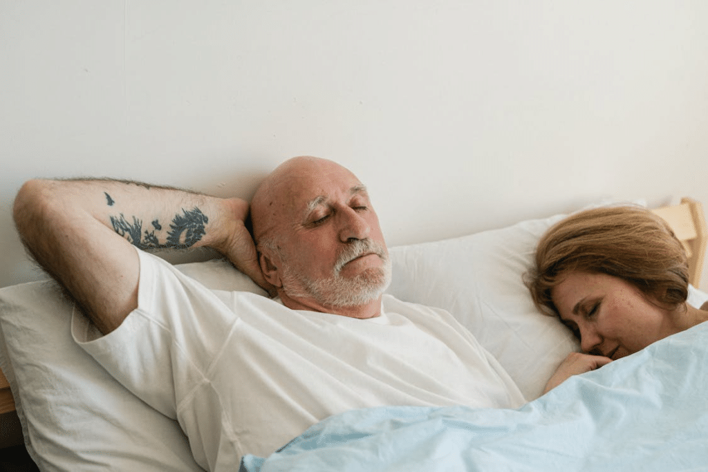 A Couple Sleeping on the Bed