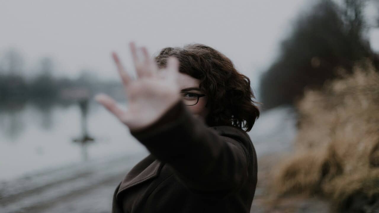 A woman saying “no” with her hand