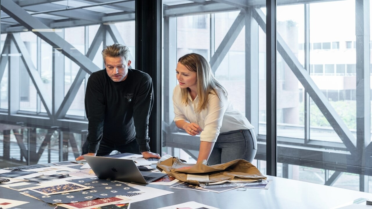 A man listens to his female colleague