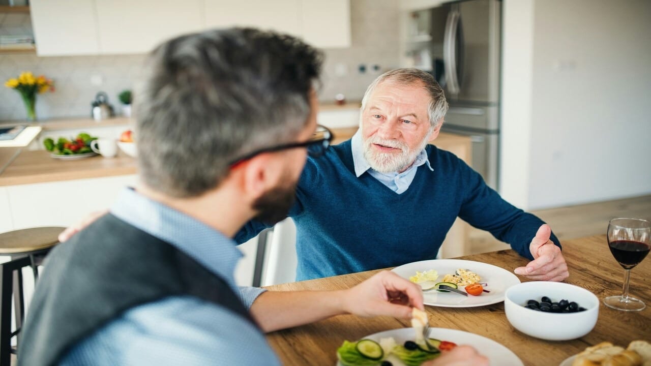 An adult son talking to his father