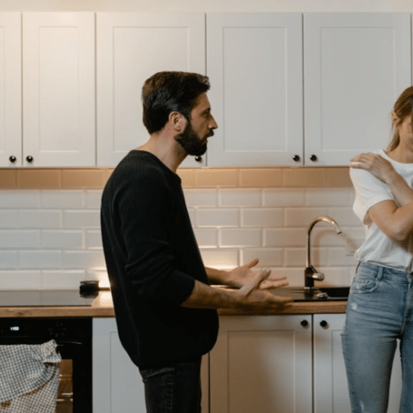 A man yelling at his wife in the kitchen
