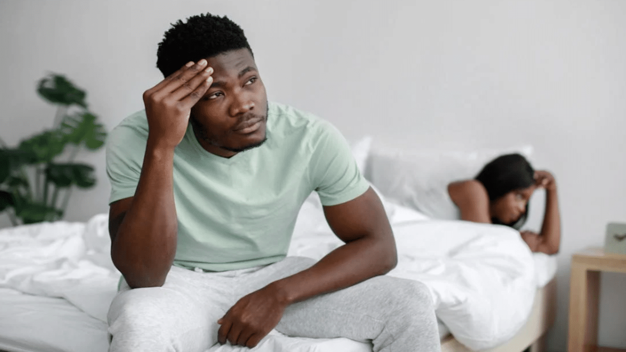 A couple ignoring each other in the bedroom