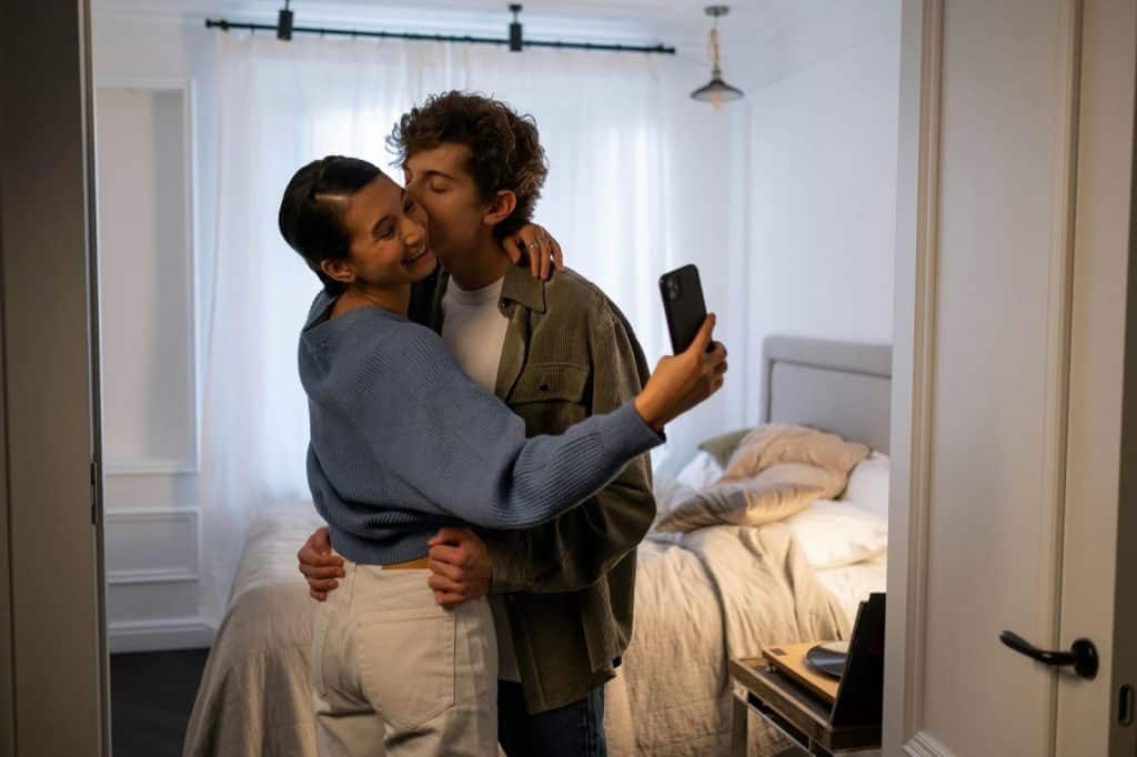 A man kissing woman’s cheek