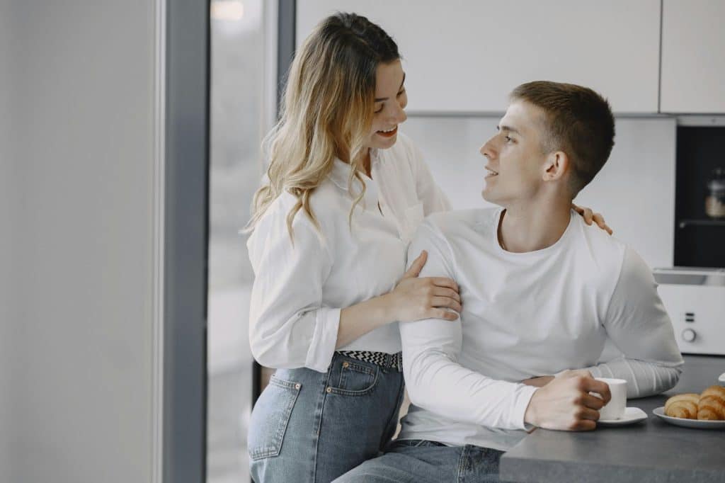 A woman approaching a man