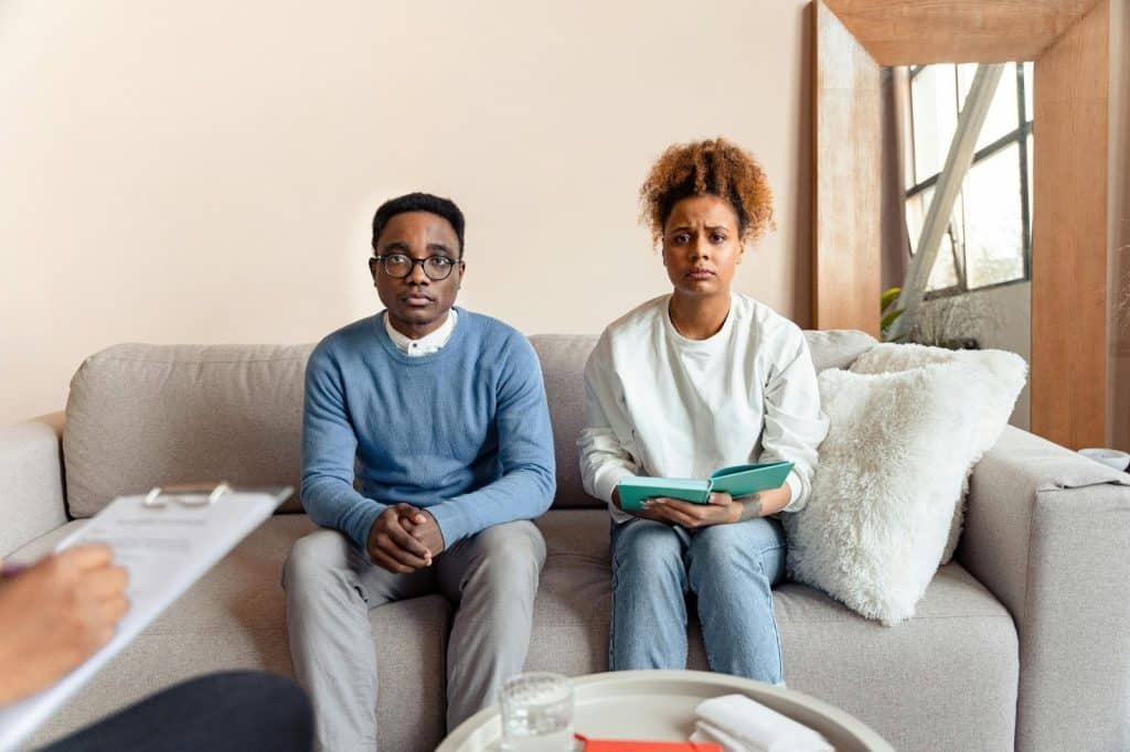 A couple sitting at the sofa