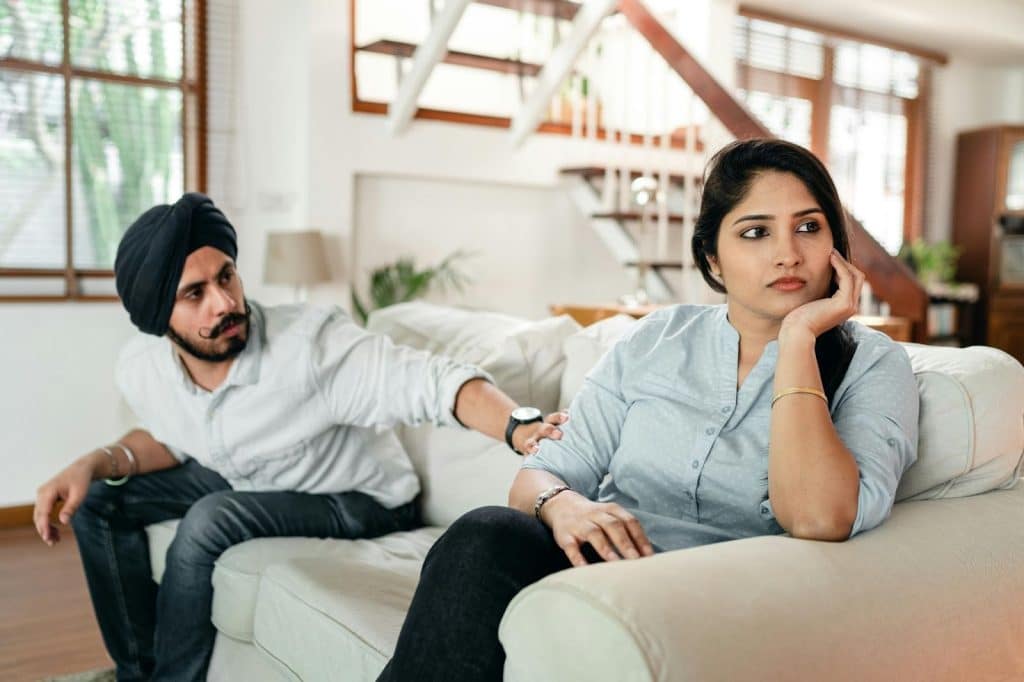 A man and woman at the couch after conflict