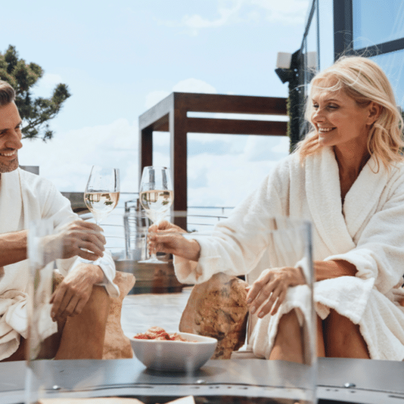 A beautiful mature couple toasting in their bathrobes