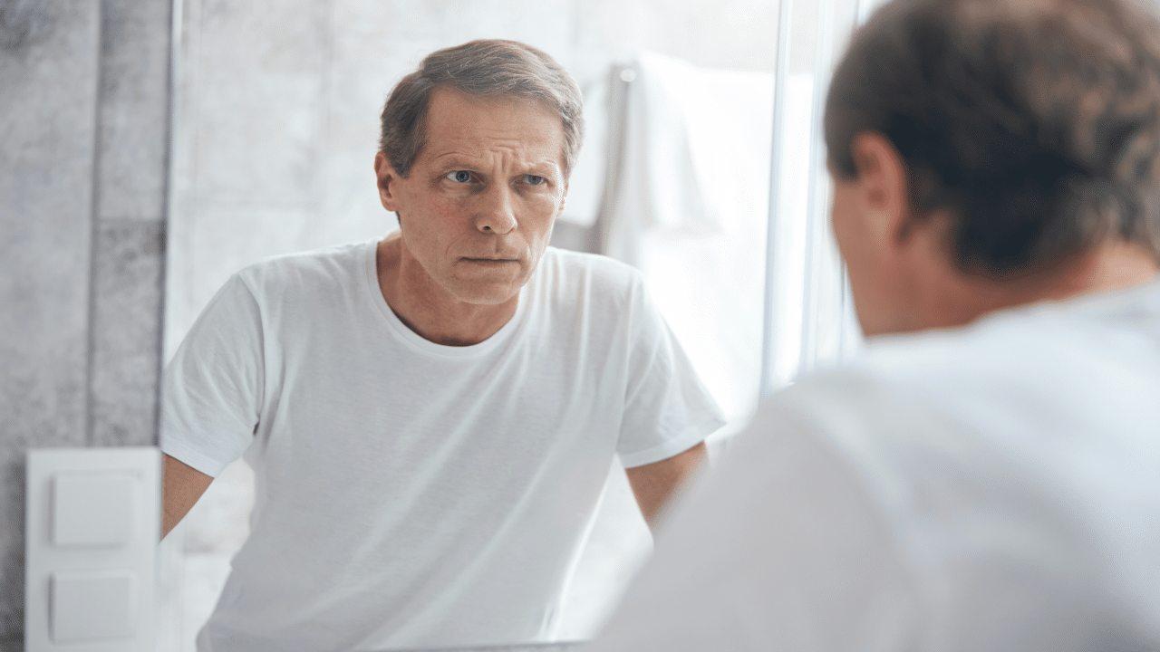 A man looking at himself in the mirror