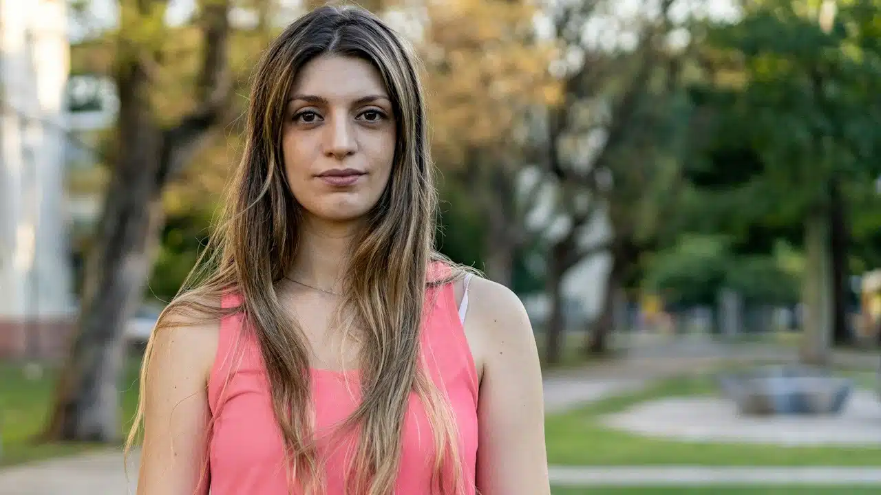 An attractive and healthy young woman after doing exercises outdoors.
