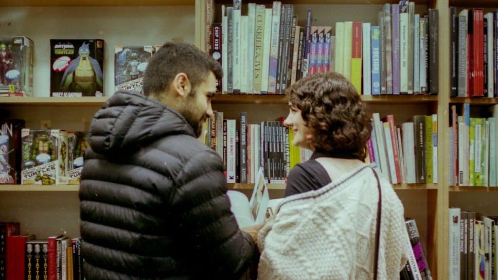 A man and woman having a bookstore date