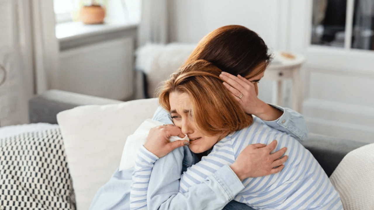 A mom comforting her crying daughter