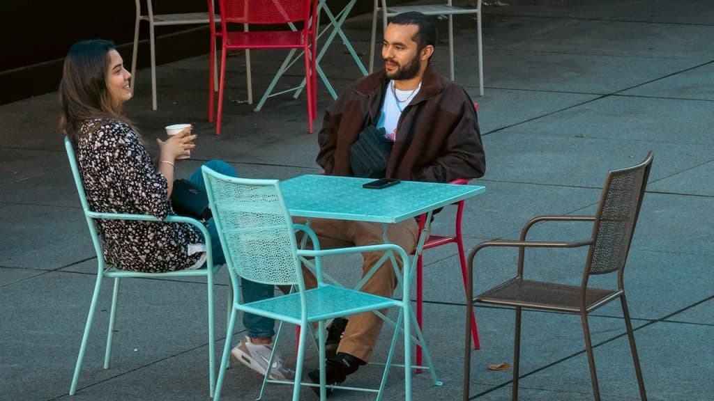 A couple sitting together outdoors.