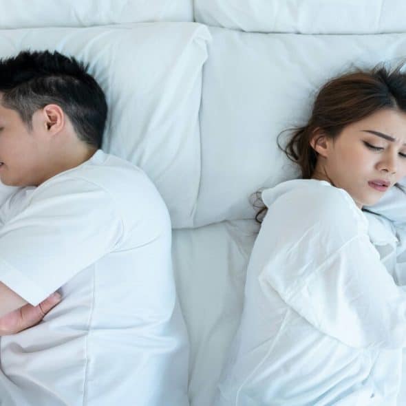 A couple sleeping back to back