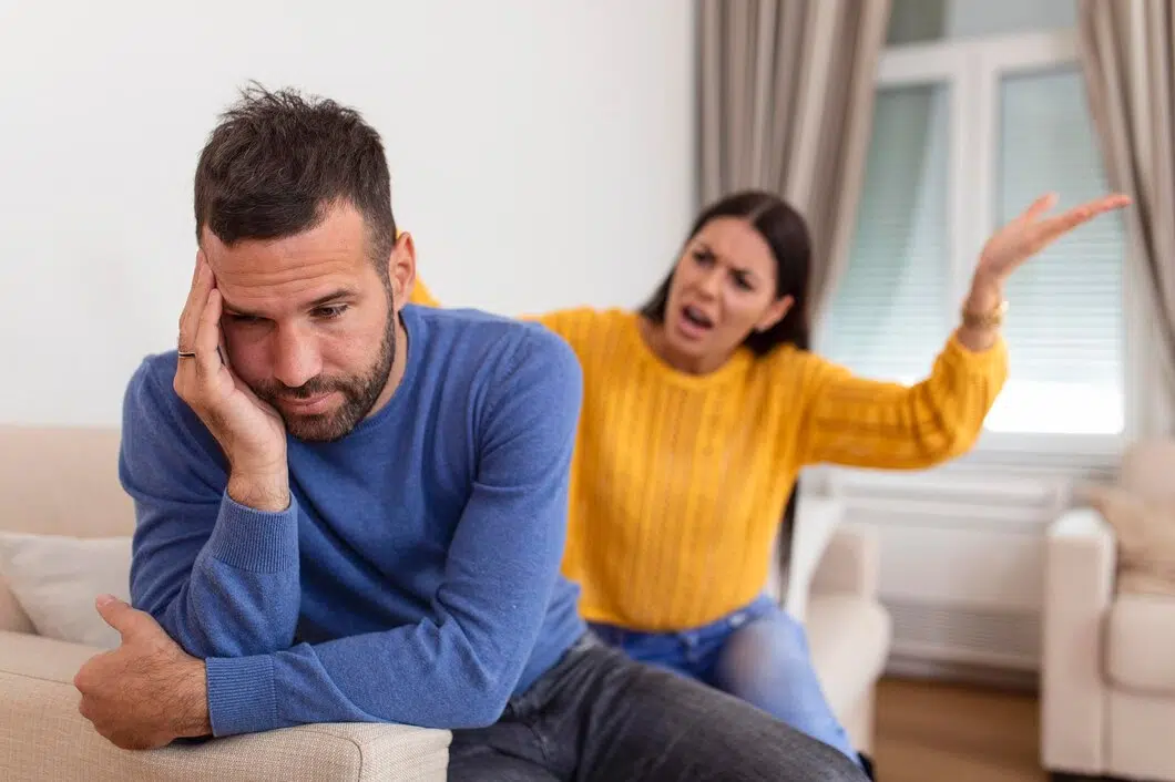 Man getting yelled at by woman