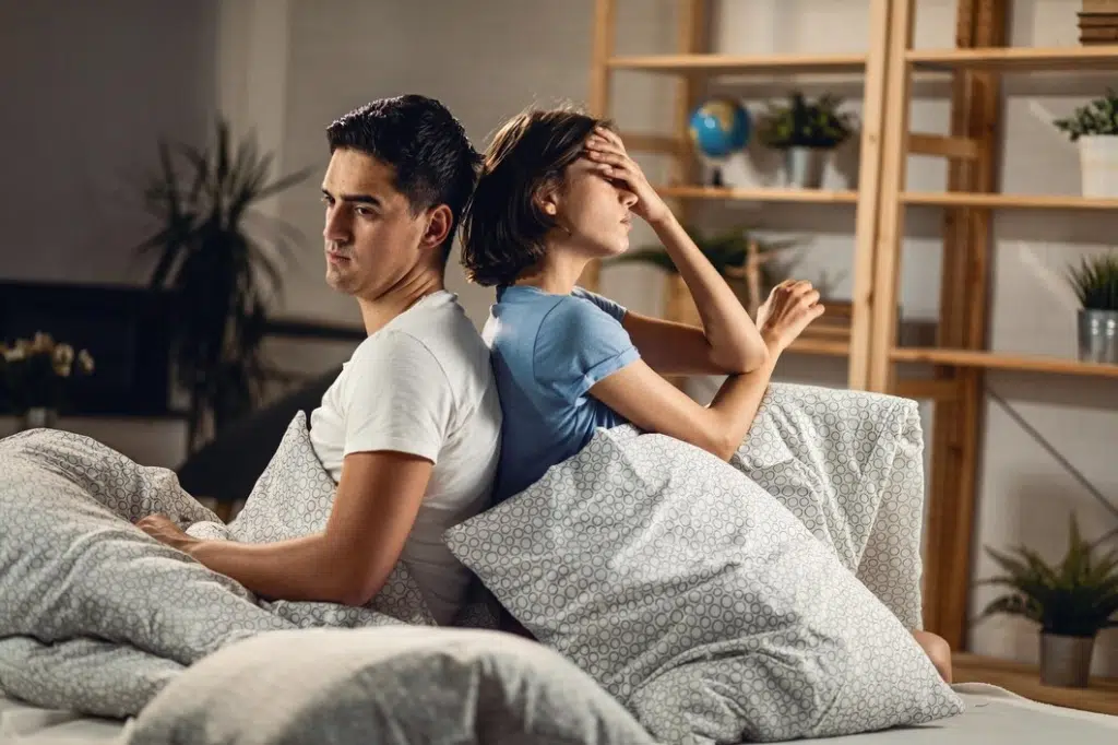 Sad couple ignoring each other while sitting