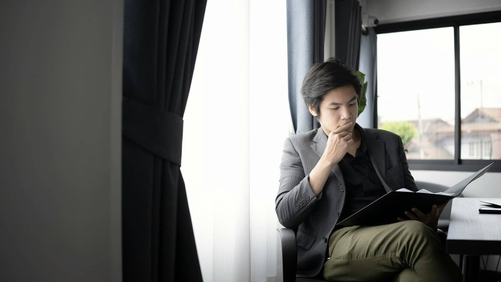 pensive man window