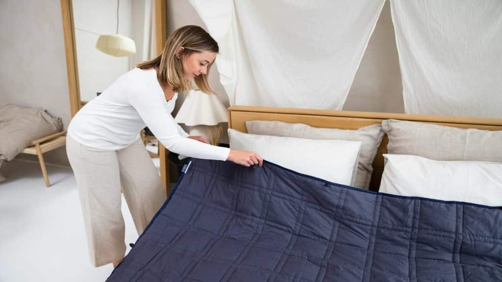 A woman fixing her bed in the morning