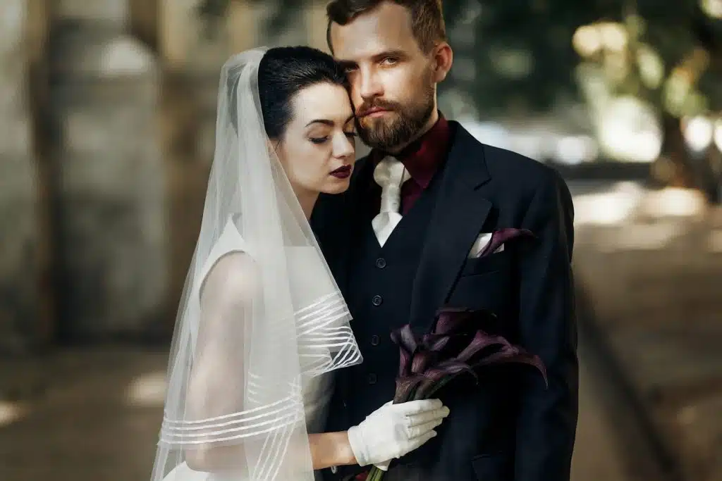 A bride and groom standing close ot each other.