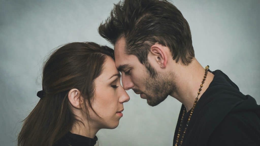 A couple touching foreheads and having a tender moment.