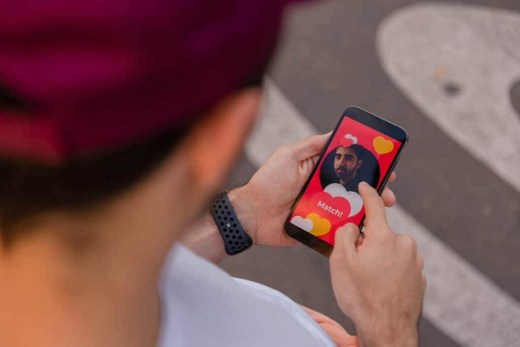 A man holding a cell phone with a picture on it.