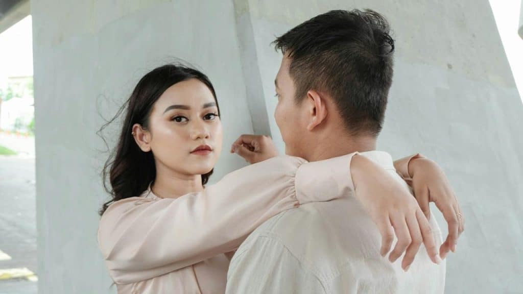 A man and a woman are standing next to each other.