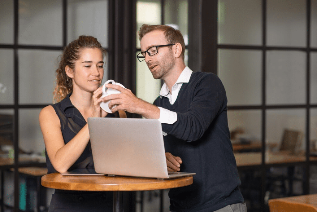 Business partners chatting and working at cafe table