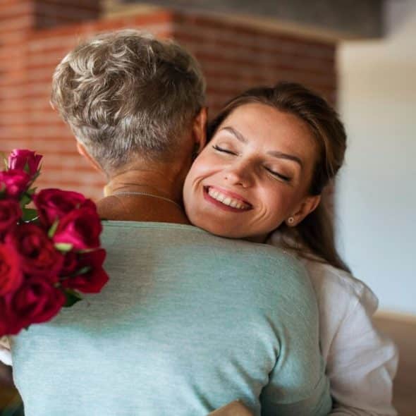 A man giving his wife flowers