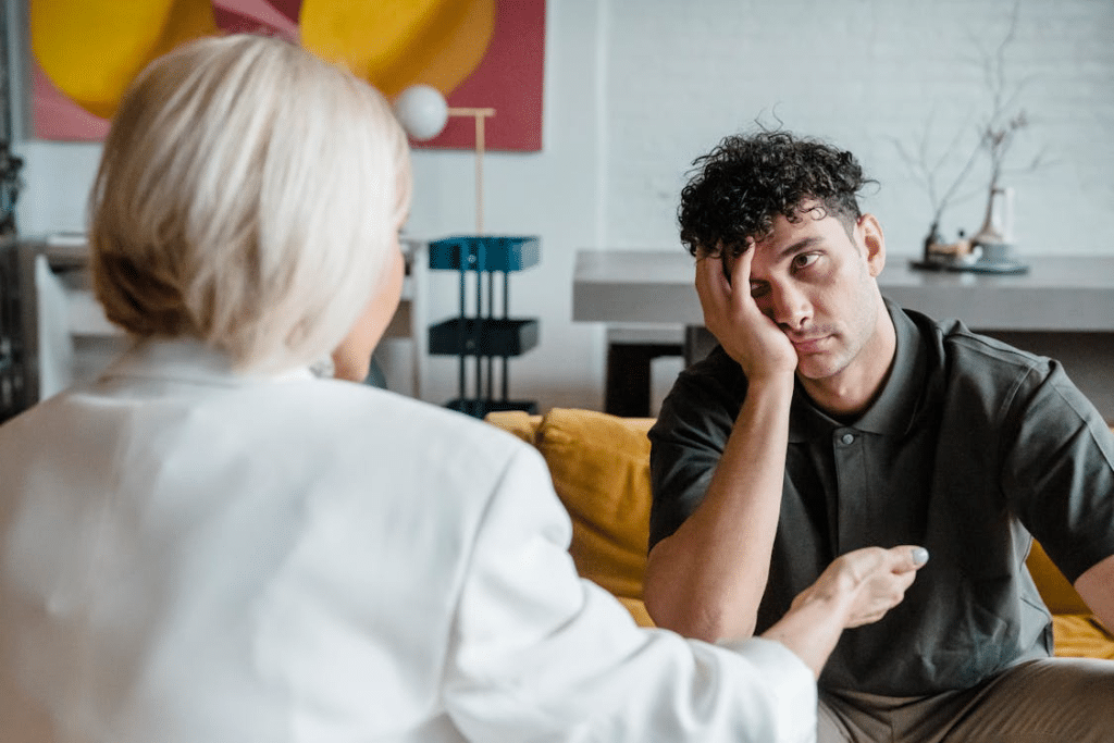 Man bored and unattentive talking to woman