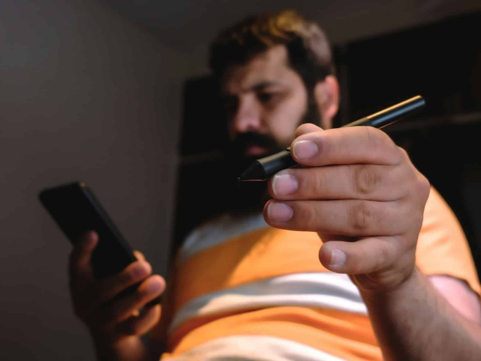 man scrolling phone night