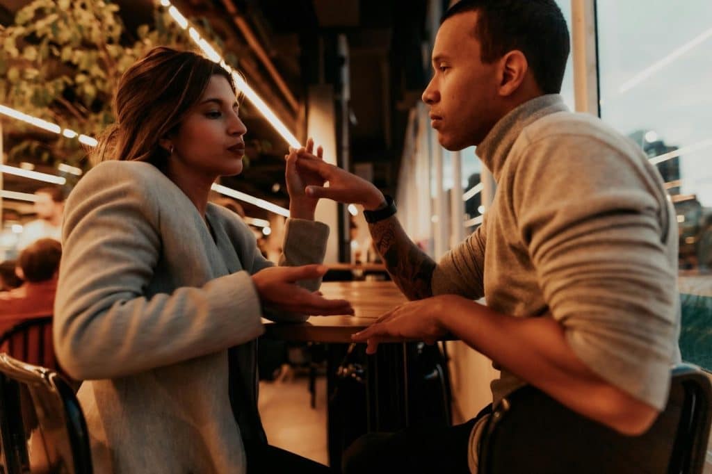 A man and a woman facing each other