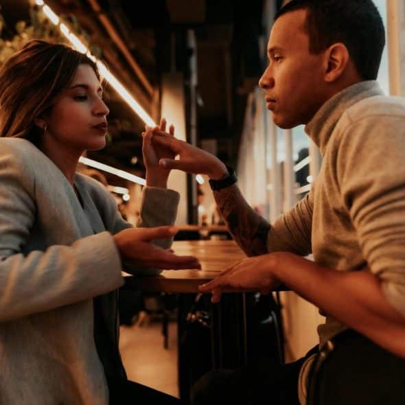 A man and a woman facing each other