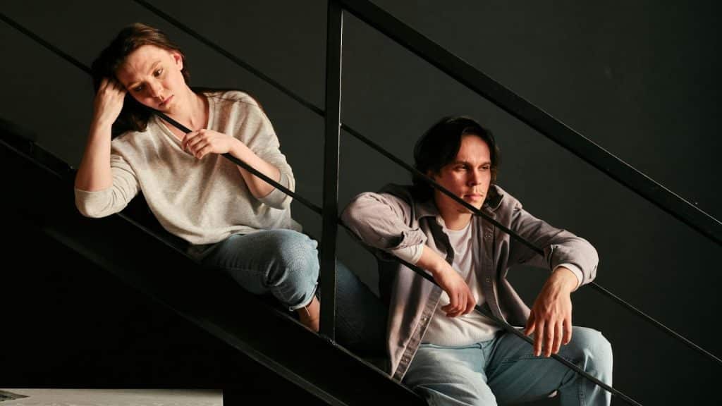 A man and woman sitting on the stairs