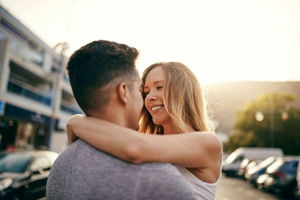 A man and woman embracing each other