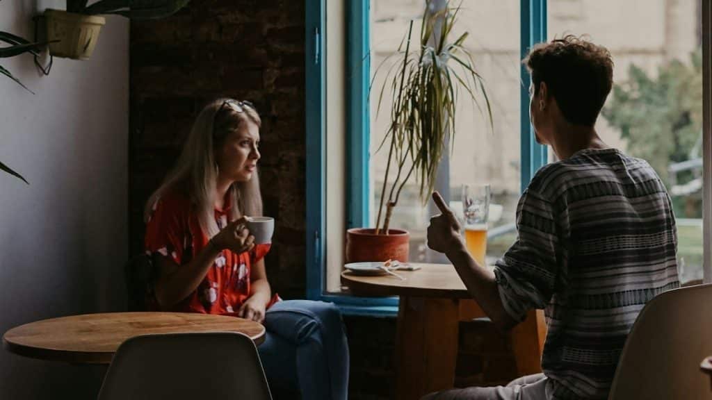 A man and woman arguing while at the cafe