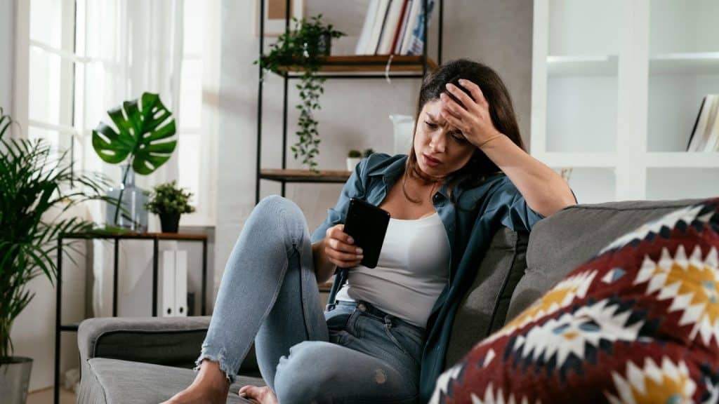 Woman looking worried using a phone