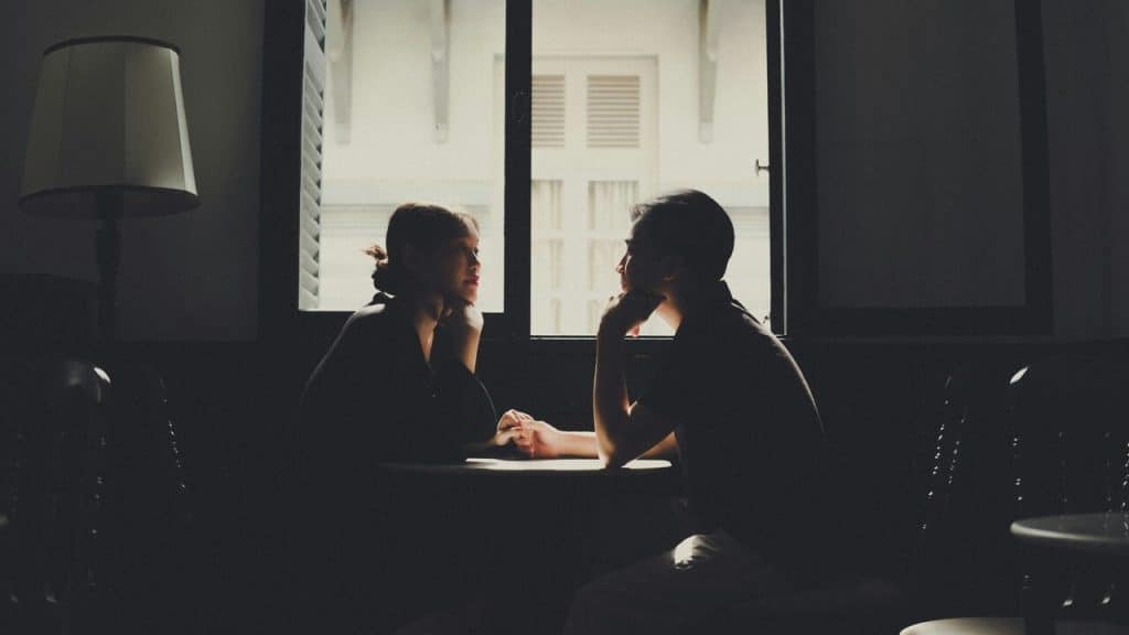 A couple talking at a cafe