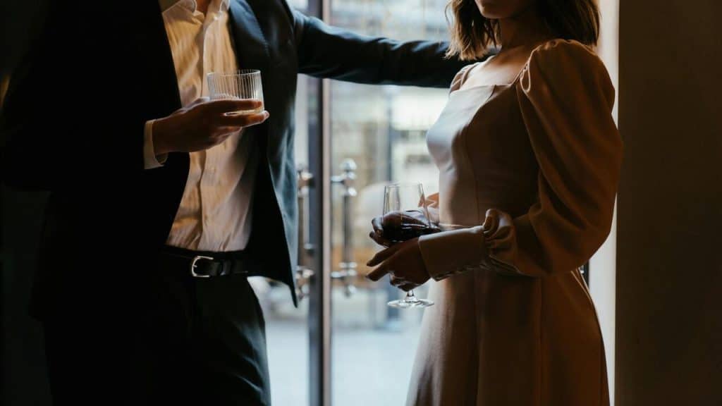 A man and a woman holding glasses