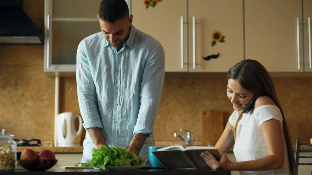 A couple busy with chores at home