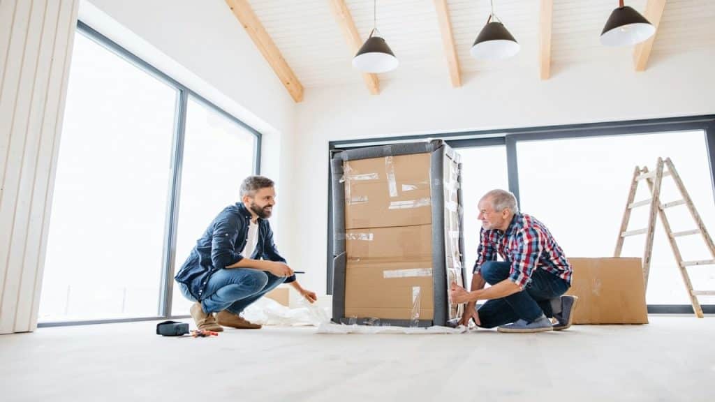 An older dad helping his son move