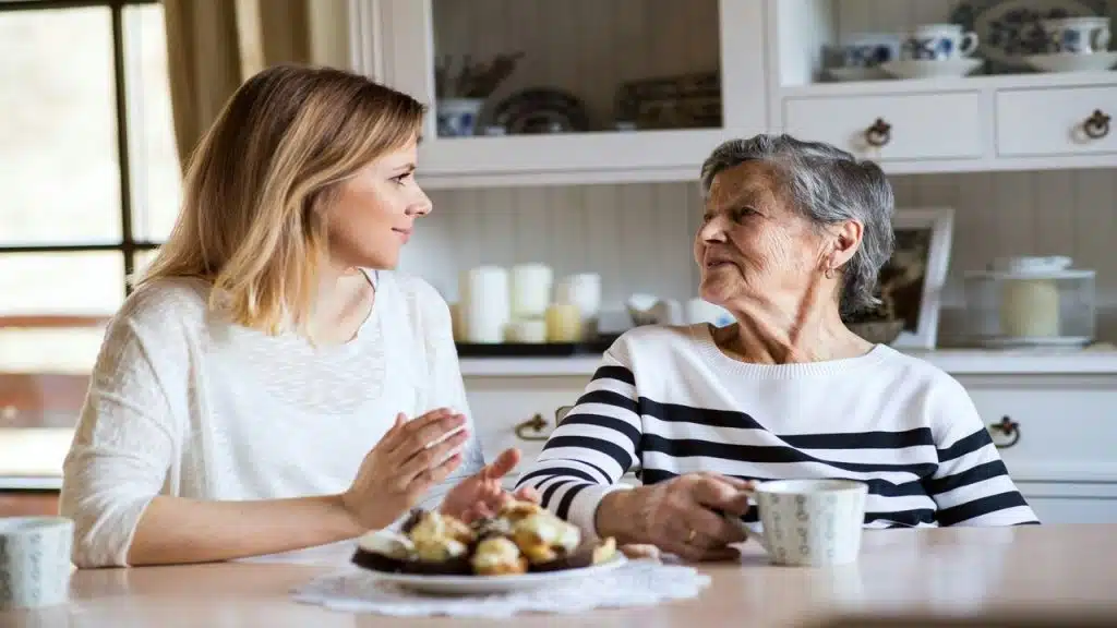 A mother and a daughter talking in the kitchen