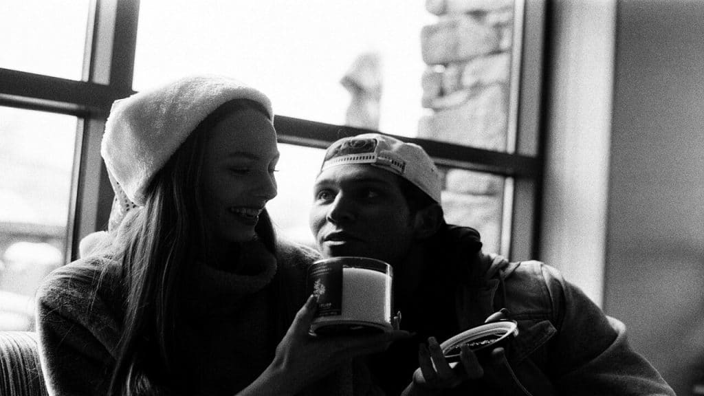 A couple talking beside a window