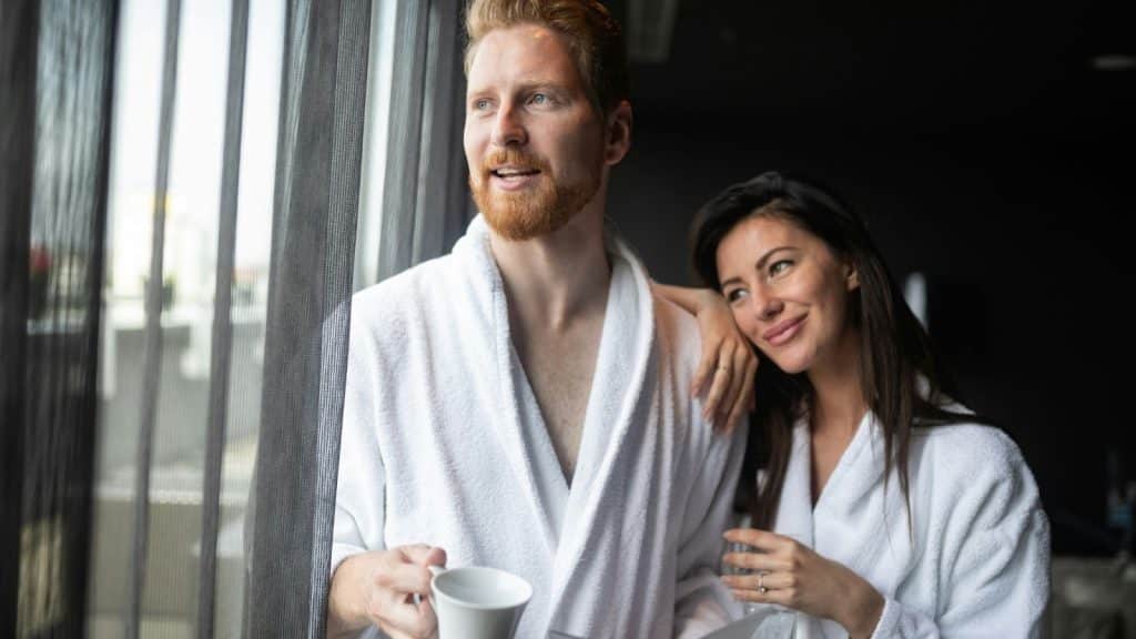 A man and woman beside the window