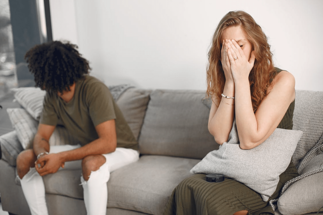 A Distant Couple Sitting on a Sofa