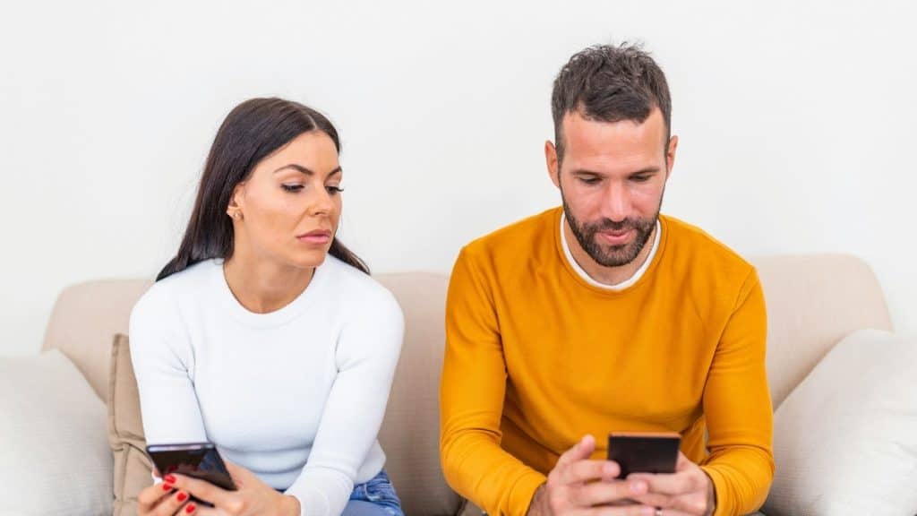 Woman looking at the man’s phone 